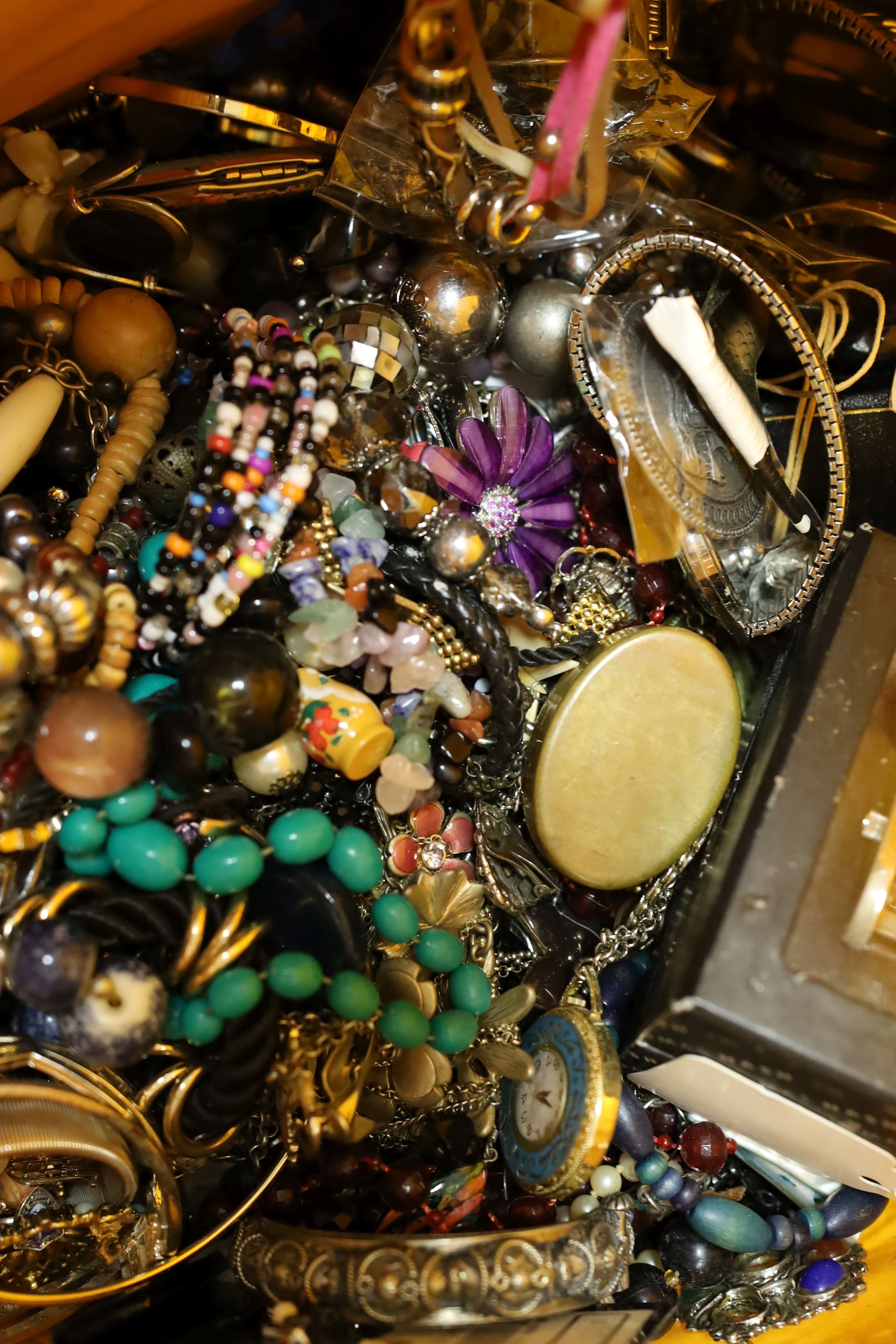 A large quantity of assorted costume jewellery, watches, clocks etc.